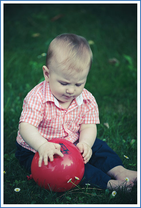 baby playing with balloon 