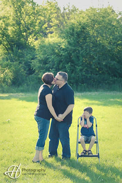 funny shot with parent kissing 