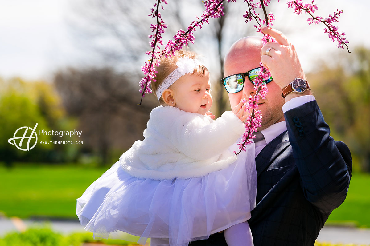 father daughter playing with flowers 