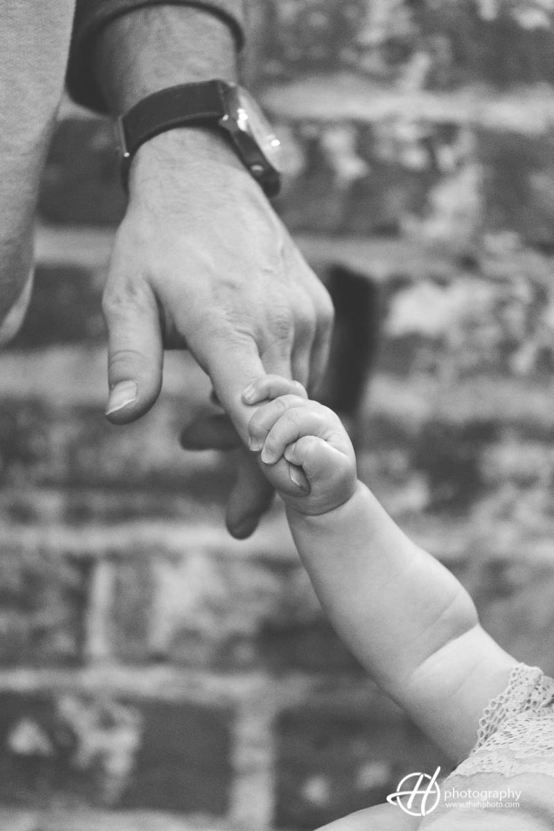 baby holding father's finger
