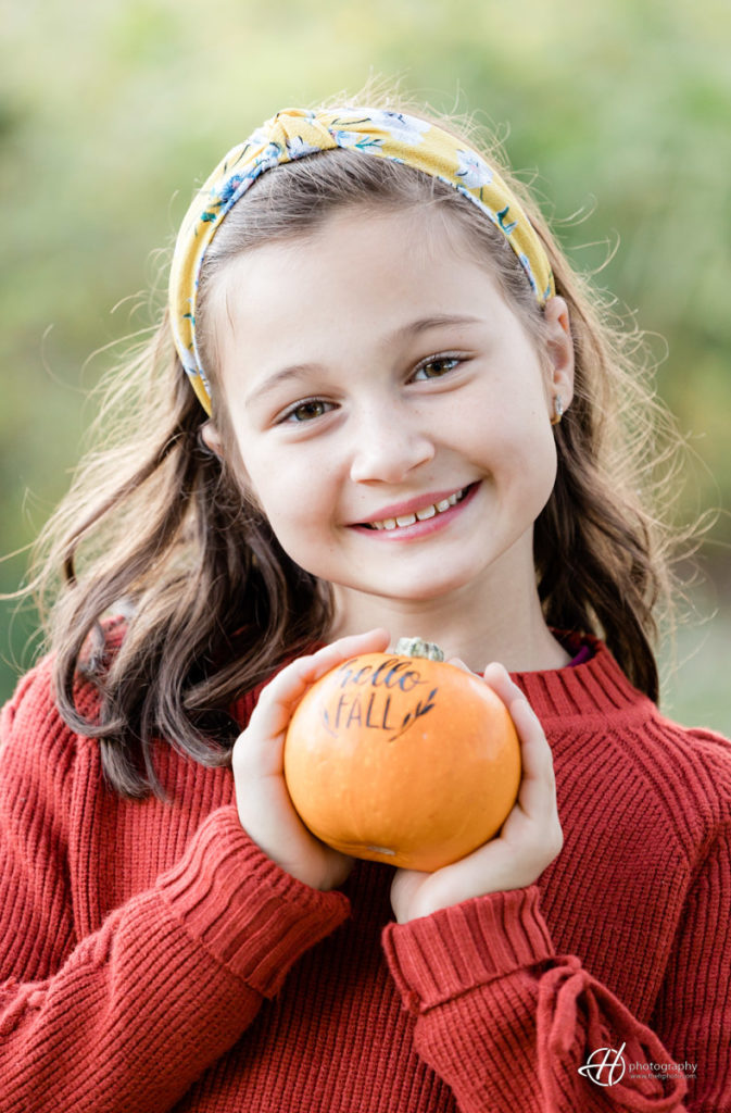 The beautiful Ariana holding a Hello Fall pumpkin! 
