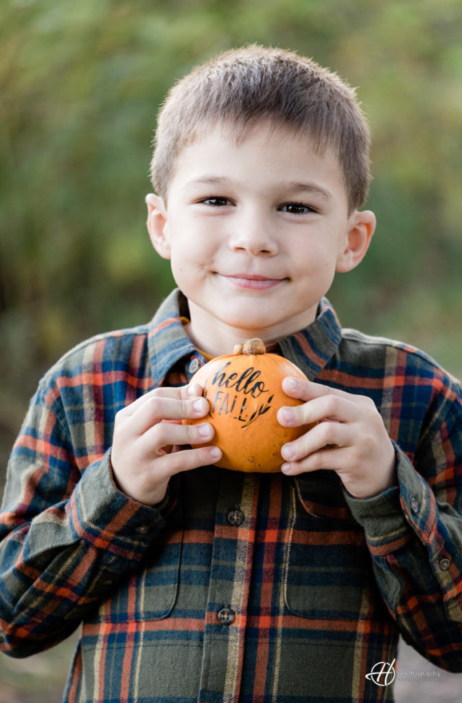 Lucian Vesa holding a Hello Fall Pumpkin! 