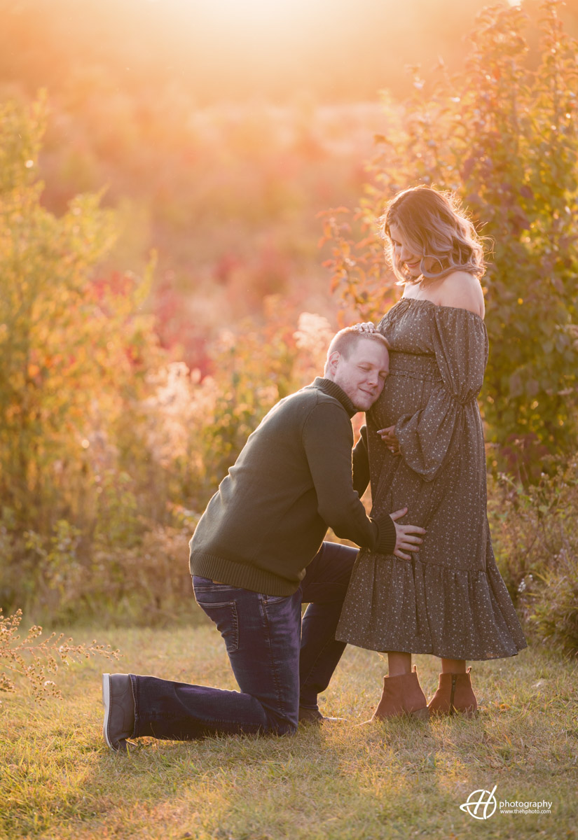 husband and wife posing with sunset light in the fall 