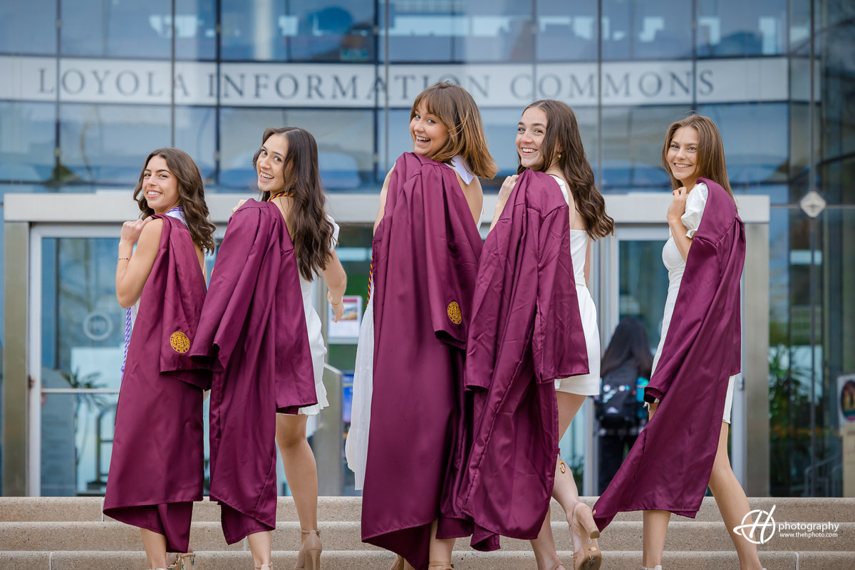 Proud and accomplished: A group of beaming Loyola University Chicago seniors stand shoulder-to-shoulder, donning their graduation gowns, emanating confidence and excitement as they embark on the next chapter of their lives