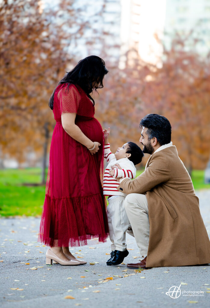 "Heartfelt family moment in South Loop Chicago's Grant Park. Roshan lovingly shows Reidan his future sister, tenderly connecting with Nimi's baby bump. A beautiful glimpse into the joyous anticipation of welcoming a new family member."