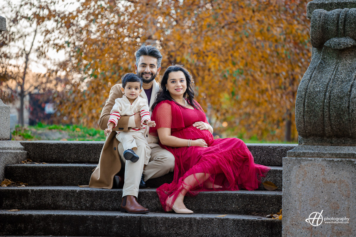 "Familial warmth on display as the family gathers on the steps, creating a harmonious scene. Reidan's playful energy, Nimi's glowing presence, and Roshan's loving support captured against a charming backdrop. A timeless family moment framed on the steps in South Loop Chicago's Grant Park."