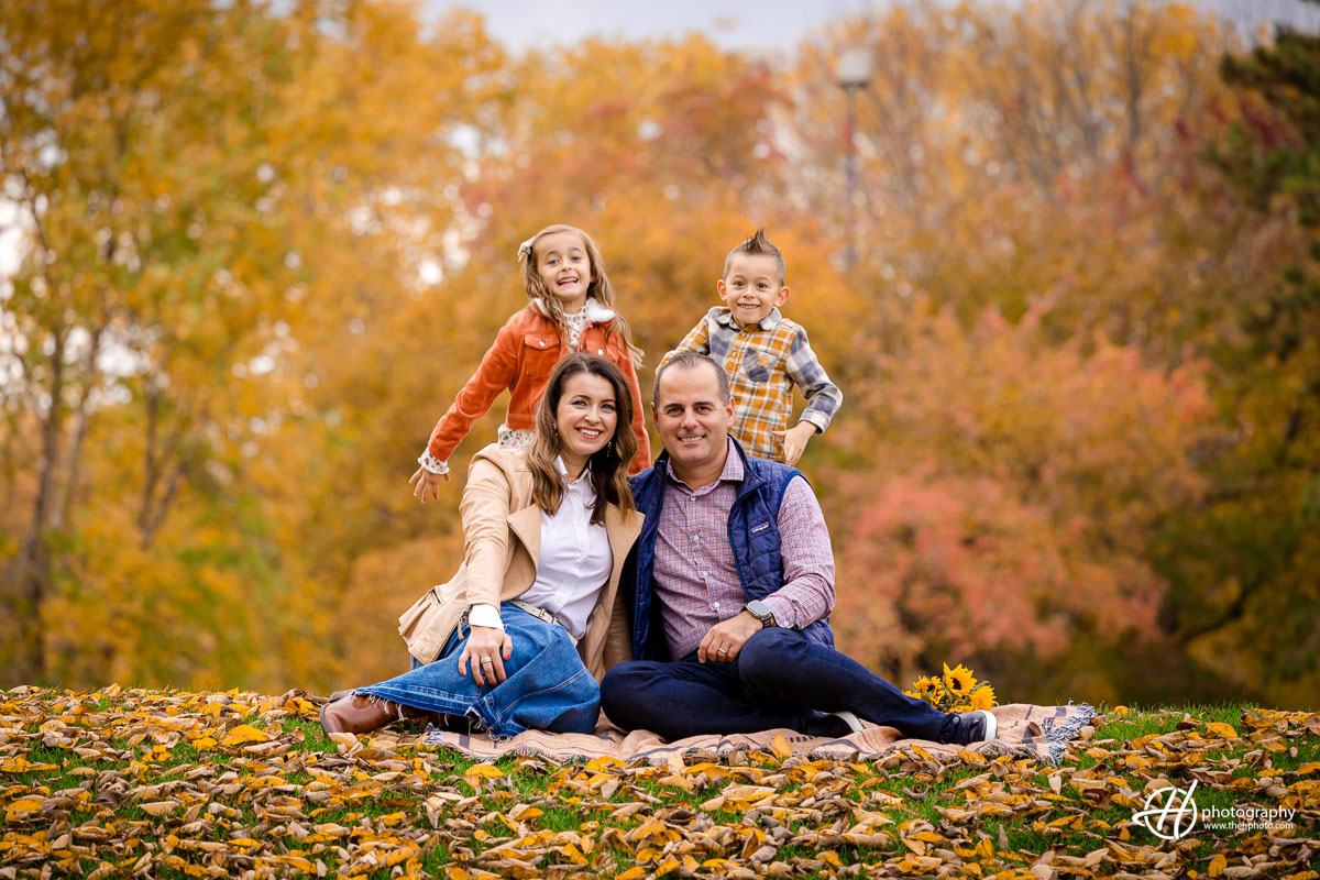 Family of four with fall background at the Sculpture Park 