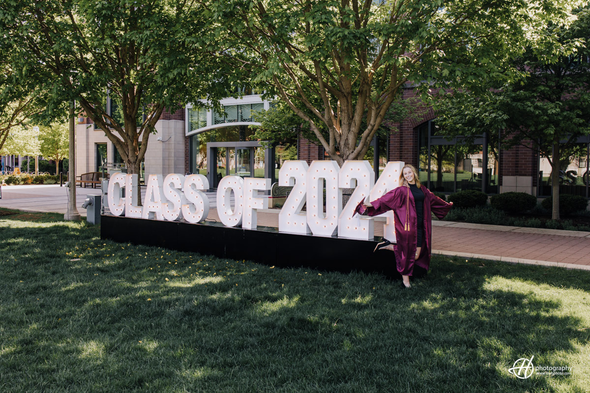 Grace posing by the Class of 2024 sign 