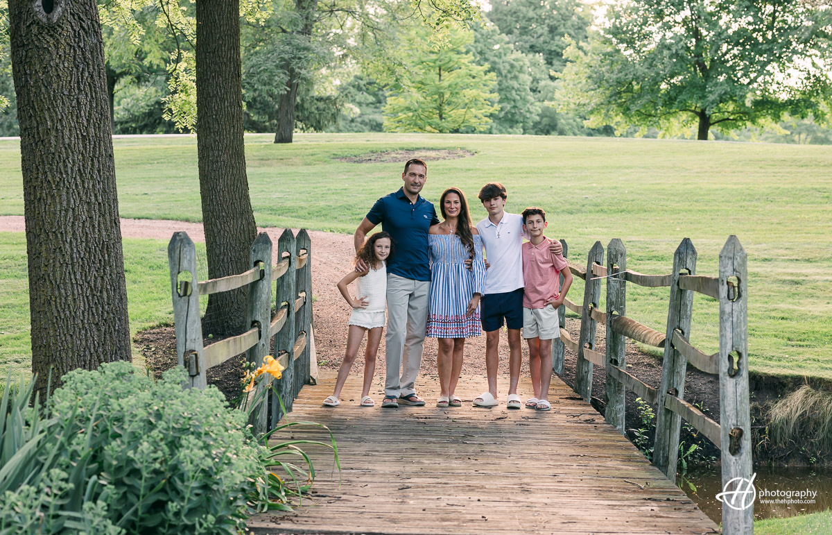 family photo on the wooden bridge at The Glen in South Barrington 