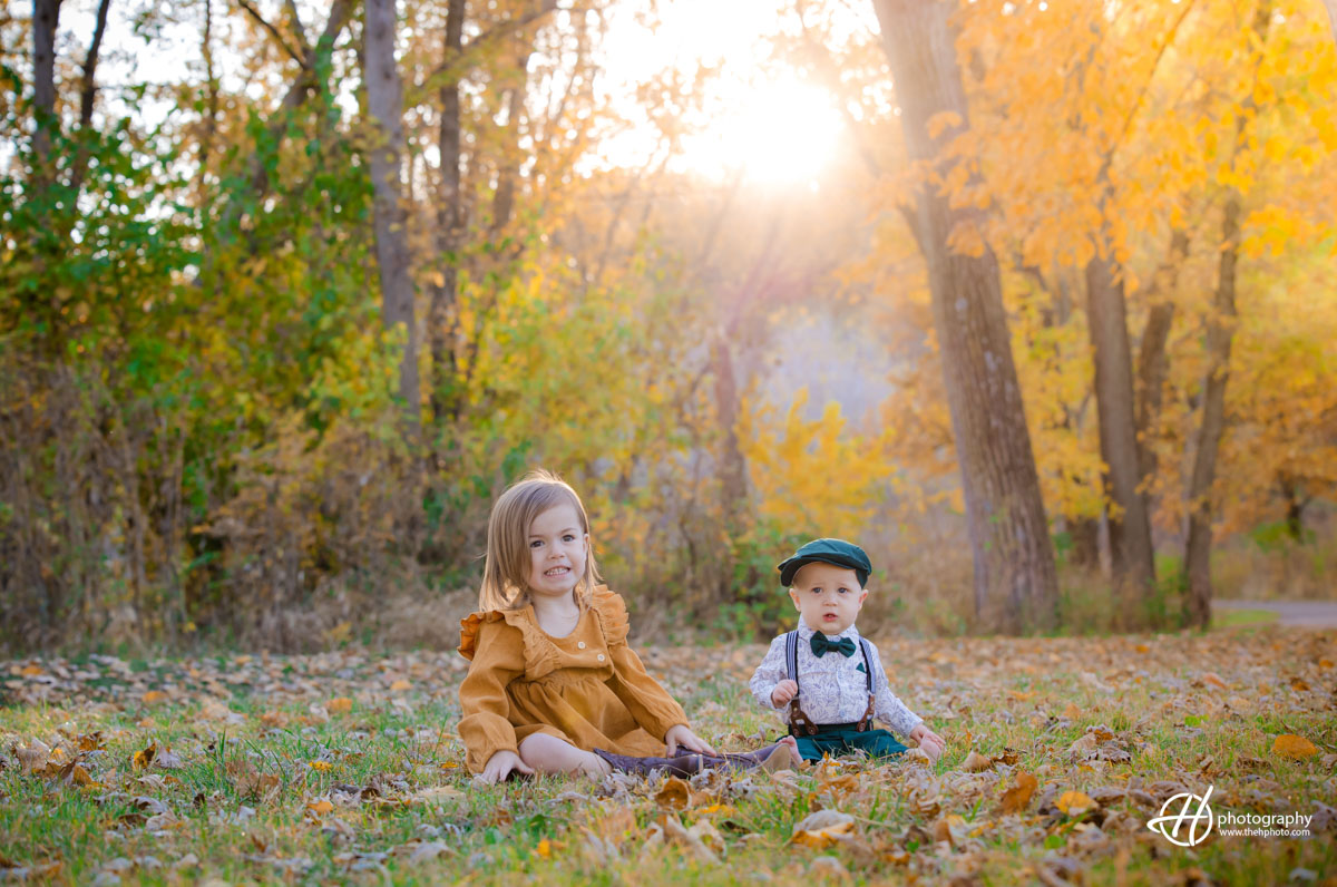 kids photo in sunset light through the golden branches 