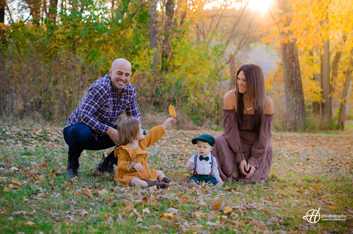 family having fun in sunset light of October 