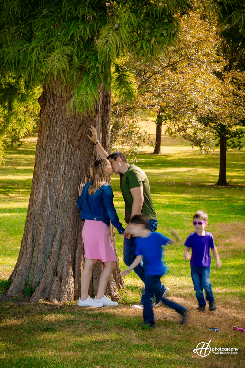 the boys running around the tree 