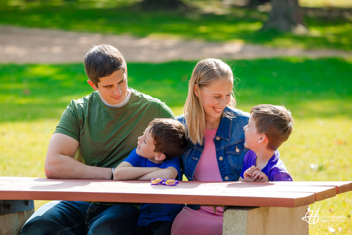 candid family shot of the Woodcox family sitting at the picnic table 