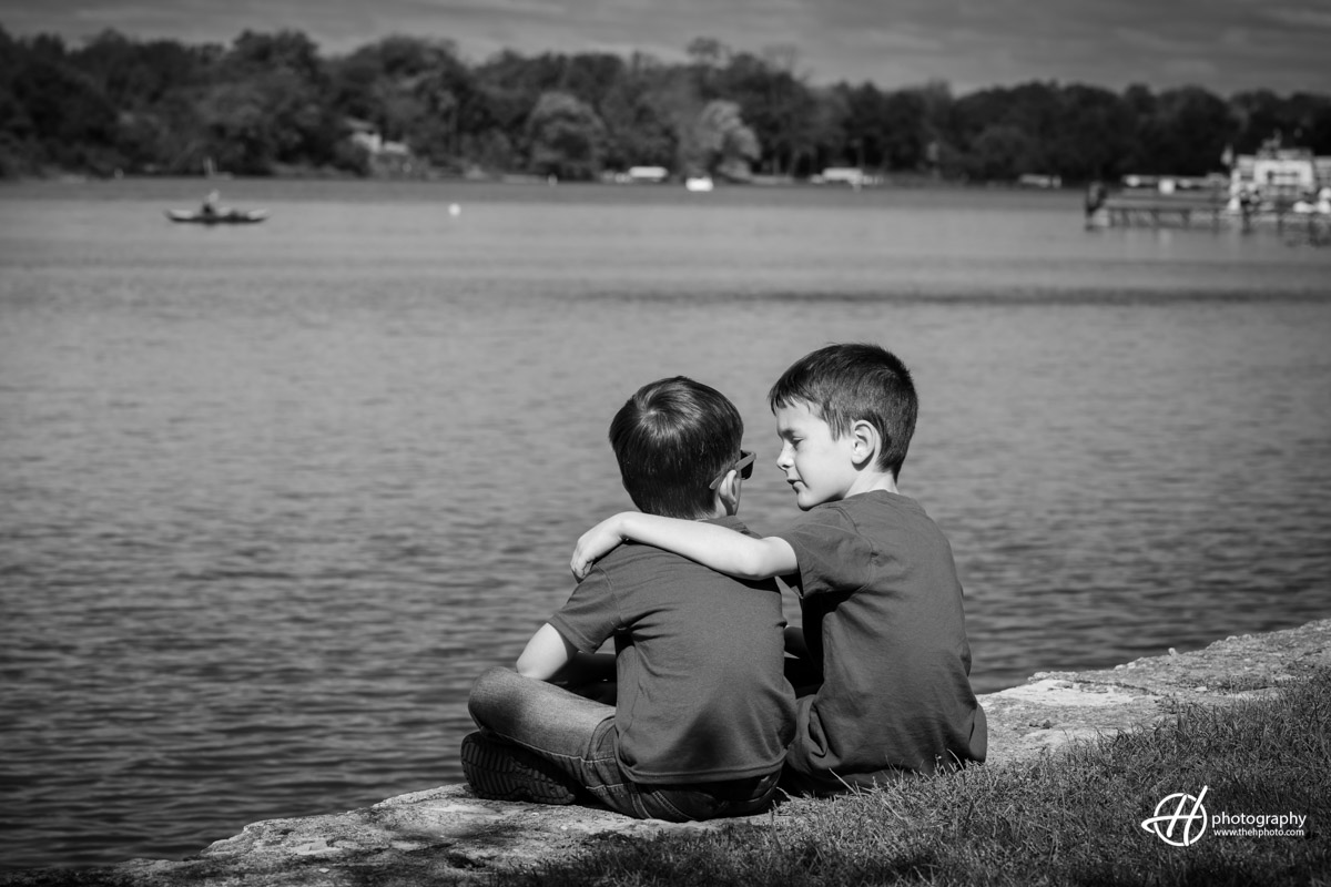 black and white candid shot of the brothers sitting by Fox River 