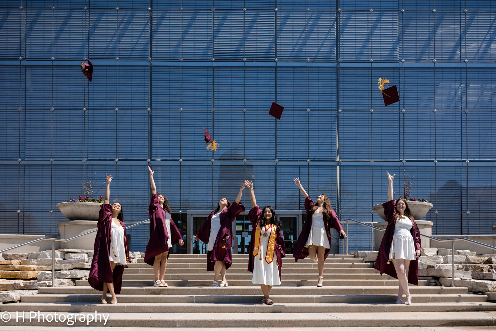 tossed their graduation caps in celebration Loyola students on the steps of commons playing with their caps