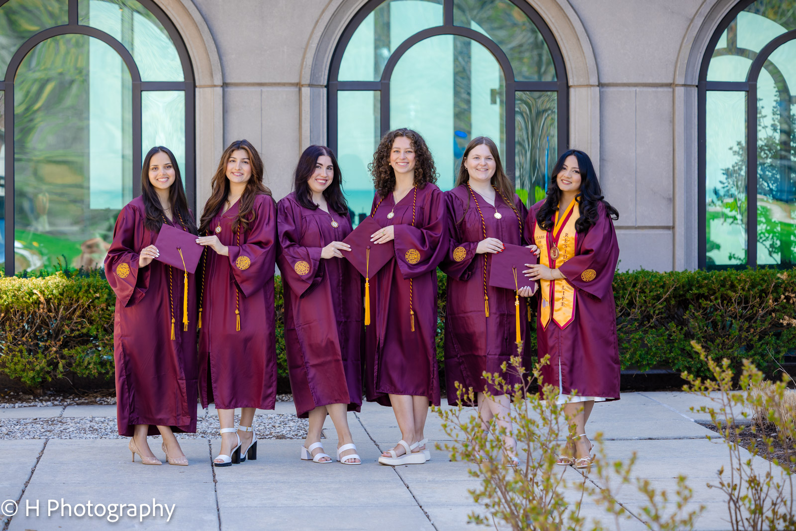 Loyola Graduation group photo holding the graduation caps