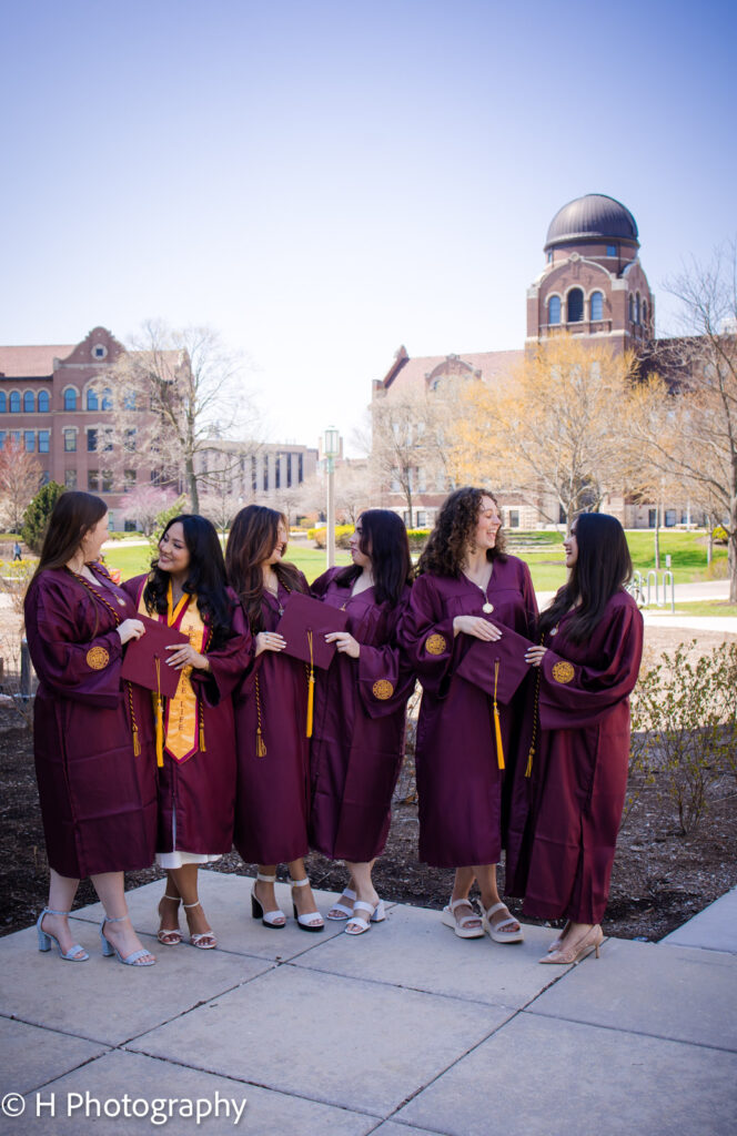 Group of Loyola Seniors chatting by the Library