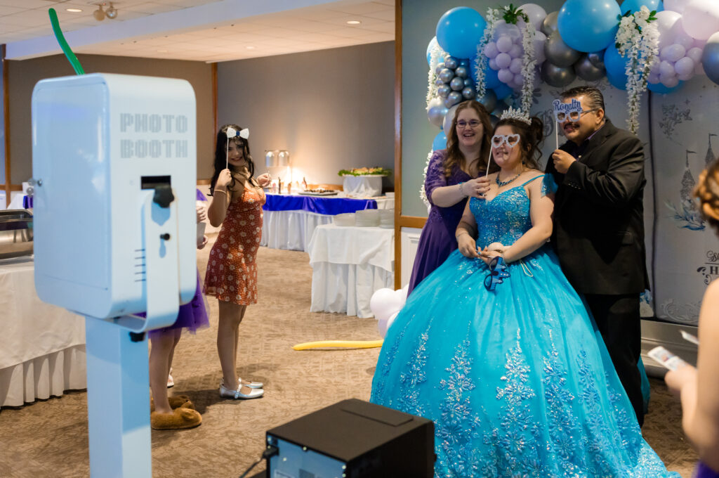 Chicago Quinceañera photo booth moment with the quinceañera and her family celebrating together.